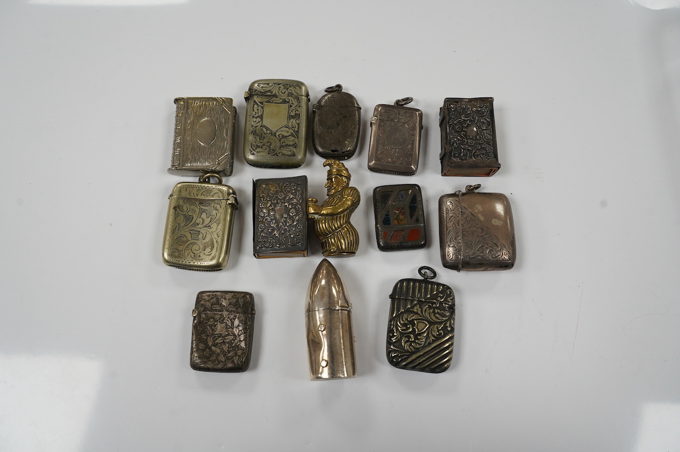 Thirteen silver and novelty vesta cases. Condition - fair